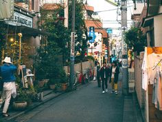 several people walking down an alley way in the city