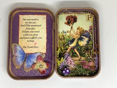 an open tin box with a fairy on it and a butterfly in the bottom half