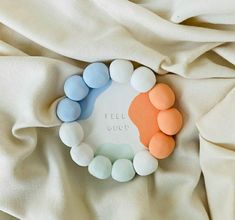 a close up of a white and blue object on a bed with the words feel good written in it