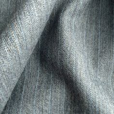 close up view of the texture of a gray suiting material, which is very soft