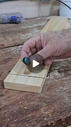 a man is working on something with a woodworking tool and sanding it down