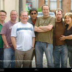 a group of people standing next to each other in front of a street sign that says, this photo brings joy to 10 million scottish people