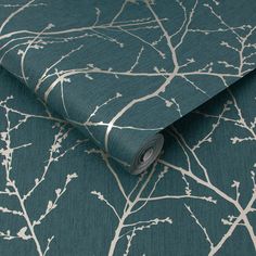 a green and white wallpaper with tree branches on the back, in an elegant pattern