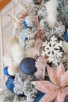 a christmas tree decorated with blue, white and pink ornaments