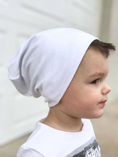 Our white color beanie is soft silky feeling! This beanie has a slouch to it also, It's rayon spandex jersey knit fabric. This item is handmade and perfect for girls or boys Sizes Small newborn-6 months Medium 6-12 months Large 1-2 year XL 2-10 Xl width 19in length 9in L width 18 in length 8in M width 16in length 8in S width 14in length 7in Width is measured for the head size Item listed only, no accessories included Wash with white colors and gentle dry on low Soft Cotton Cap, Casual Soft Bonnet One Size Fits Most, Cotton Hat, One Size Fits Most, White Bonnet Hat One Size Fits Most, Casual Soft White Hat, Casual White Soft Hat, Super Soft Cotton Hat, One Size Fits Most, Super Soft Cotton Hat One Size, Cute Soft Beanie One Size Fits Most