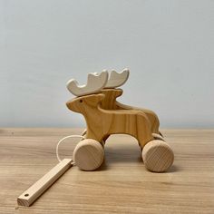 a wooden toy with a moose on it's back