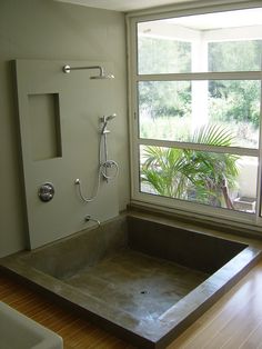 an empty bathroom with a large tub and window