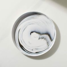 a white and black bowl sitting on top of a table