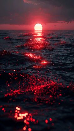 the sun is setting over the ocean as it reflects in the water's surface