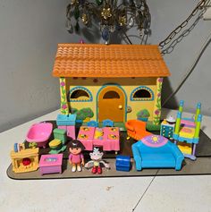 a toy house with lots of toys on the floor