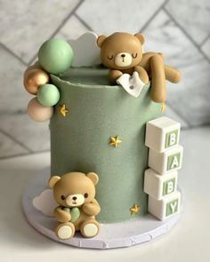 a baby shower cake with two teddy bears on top