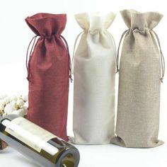 three wine bags and a bottle of wine