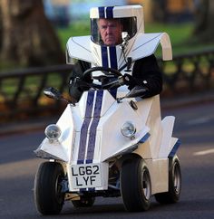 a man riding on the back of a white four wheeled vehicle