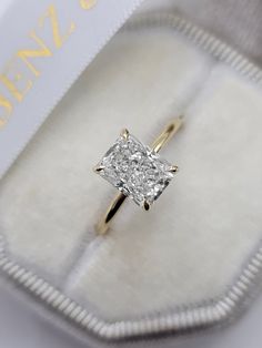 This astonishing stand alone style ring has a 2 carat lab grown radiant cut center diamond and is IGI certified at "F" in color and "VS1" in clarity, (Excellent Cut, Polish and Symmetry) and is set in a classy solitaire plain razor thin setting in 14K yellow gold. The ring can also be made in white/rose gold or platinum and can even be redesigned to your choice. Comes with IGI certification and our lifetime warranty as well. Emerald Cut Diamond Ring 2 Carat, Gold Band Solitaire Engagement Rings, Gold Engagement Ring Rectangle Diamond, Radiant Cut Engagement Ring Carat Sizes, Good Radiant Engagement Ring, Rectangular Solitaire Ring, 2.4 Carat Engagement Ring, Radiant Cut Engagement Ring Lab Grown