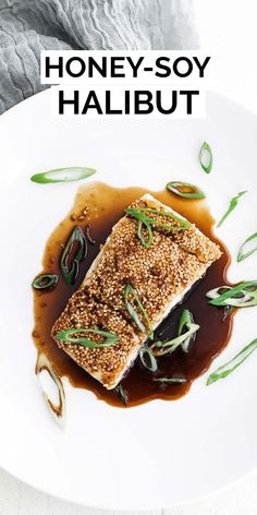 honey soy halibut on a white plate with brown sauce and sprinkles