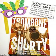 there is a mardi gras mask next to a book with the words trombonee shorty on it