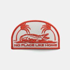 a red and white patch that says no place like home