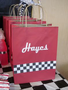 some bags are sitting on a table with candy and candies in them for someone's birthday party