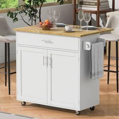 a kitchen island cart with two wine glasses on it