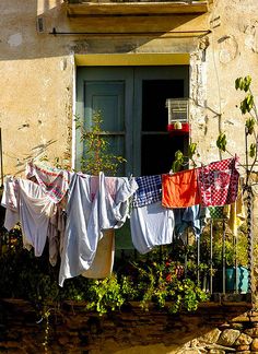 clothes hanging out to dry in front of a window