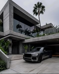 a black suv parked in front of a house