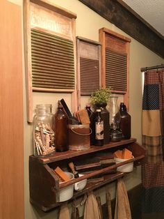 an old wooden shelf with jars and other items on it