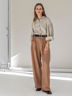 "Wide leg linen pants that are probably the most elegant and stylish in our collection. These high waist, well-fitting trousers have all key elements of classic masculine pants: fastening with a front zipper, front slant pockets and a back welted-edge pocket. The pants are accented with wide belt loops. This fashionable pick won't leave you unnoticed. STYLE DETAILS * Relaxed fit * Wide, pleated, straight leg * High waist * Fastens with a zipper and 2 buttons (one visible and one hidden)  * Slant side pockets and welted-edge back pocket * Wide belt loops * Full length * Made from medium linen SIZES & COLORS IN PICTURES * Model wears size S/M in color Rusty. She is 176 cm (5'9\"). Bust - 81 cm (32\"), waist - 67 cm (26\"), hips - 90 cm (35\"). NOTES ON SIZING & COLORS * Please note that line Beige Linen Wide Leg Pants For Fall, Spring Wide Leg Pants With Button Cuffs, Chic Formal Linen Wide Leg Pants, Chic Wide Leg Straight Pants With Button Cuffs, Chic Wide Leg Pants With Button Cuffs, Elegant Wide Leg Relaxed Fit Culottes, Elegant Relaxed Fit Linen Pants, Chic Wide-leg Pants With Button Cuffs, Elegant Linen Bottoms With Relaxed Fit