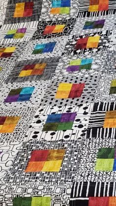 a colorful quilt with squares and lines on it