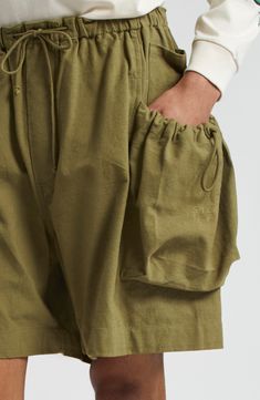 Crafted of organic-cotton slub fabric, these drawstring-waist shorts feature a loose, relaxed fit with roomy cargo-style bellows pockets on each side. 7" inseam; 32" leg opening; 15" front rise; 18" back rise (size Medium) Drawstring waist Cargo bellows pockets 100% organic cotton Hand wash, dry flat Imported Designer Clothing Asian & Pacific Islander Owned/Founded Organic Fabric Fashion, Pocket Design Fashion, Cute Hiking Outfit, Story Mfg, Pacific Islander, Organic Fabric, Paper Bag Shorts, Drawstring Waist Shorts, African Men Fashion