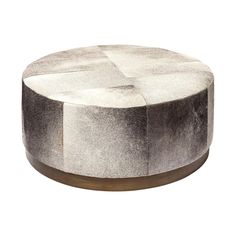 a white and black ottoman sitting on top of a wooden table