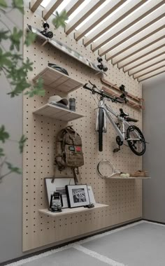 there is a bike hanging on the wall next to some shelves with pictures and other items