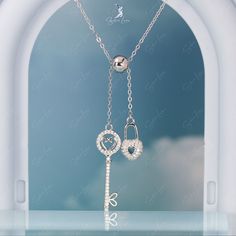 Indulge in the beauty and romance of this stunning heart lock and key pendant necklace. Crafted with solid 925 sterling silver and adorned with a sparkling cubic zirconia pave lock, this necklace is an exquisite piece that can be adjusted to wear as both a pendant and a necklace. The elegant platinum plating and cable chain style add a touch of luxury to this must-have accessory. Perfect for adding to your everyday fine jewelry collection or giving as a heartfelt gift to your special someone. Ma Elegant Heart-shaped Necklace With Two Keys, Heart Lock And Key, Key Pendant Necklace, Heart Lock, Lock And Key, Key Pendant, Fine Jewelry Collection, Heartfelt Gifts, Hanging Pendants