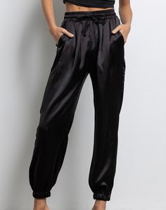 Color: Black Satin Jogger Elastic Waist With Drawstring Elastic Band At Ankle Pockets 100% Polyester Model is 5'8" 32-24-34 wearing a small Matching Satin Bomber- "Laverne" IJ2460 Black Silk Joggers Outfit, Black Satin Joggers Outfit, Satin Joggers Outfit Dressy, Silk Joggers Outfit, Satin Joggers Outfit, Black Satin Pants Outfit, Jogger Outfit Casual, Satin Pants Outfit, Vegas Looks