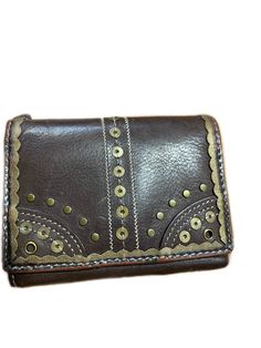 Brown leather wallet embellished with gold toned design elements Unisex trifold Card holder, bills and zippered compartment for change Brown Leather Wallet, Passport Wallet, Money Clip Wallet, Travel Wallets, Trifold Wallet, Vintage Bags, Coach Dinky Crossbody, Purse Wallet, Money Clip