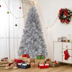 a christmas tree with presents under it in a room decorated for the holiday season,