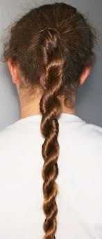 the back view of a woman's head with long hair in a fishtail braid