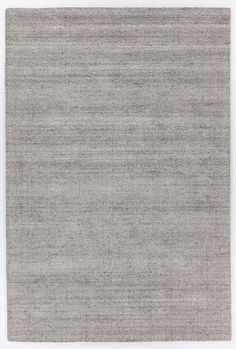 an area rug with grey and white colors