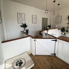 a dog bed in the corner of a room with white walls and wood flooring