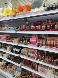 the shelves are filled with various types of cosmetics and other items for sale in a store