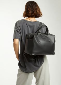 Emmy Midi is a “just right” sized tote style diaper bag with the same features as the full sized version, so everything you and baby need is easy to see and reach. Our microfiber vegan leather makes Emmy structured yet slouchy and is so durable that it doesn’t need to be babied. She works best as a shoulder bag or crossbody but can be converted to a backpack when you want to be hands-free. From jeans and sneakers to yoga pants or a party dress, Emmy’s clean lines enhance any style. Ideal for new Everyday Large Capacity Duffle Bag With Double Handle, Modern Weekender Bag With Large Capacity, Everyday Duffle Bag With Removable Pouch And Double Handle, Versatile Leather Diaper Bag With Double Handle, Modern Leather Diaper Bag With Large Capacity, Large Capacity Leather Diaper Bag Modern Style, Everyday Soft Leather Duffle Bag With Double Handle, Everyday Leather Diaper Bag With Top Carry Handle, Everyday Leather Diaper Bag With Double Handle