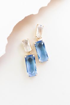 Polish off your look with sophistication in our Charlotte earrings! Rectangle-cut blue & clear topaz crystals hang elegantly, adding a hint of sparkle to your ensemble. These would make the perfect finishing touch to a bridal party look! Crystal rectangle cut drop earrings, Sapphire & clear, Post backs, Approx 1.75" Blue Earrings Aesthetic, Blue Bridal Jewelry, Simple Wedding Earrings, Earrings Rectangle, Earrings Sapphire, Bridesmaid Ideas, Earrings Aesthetic, Gem Earrings, Party Look