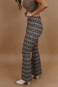 Take me back in time, this 70's inspired pant is featured in a true-to-size fit with a wide-leg style bottom and slimming high-waisted design. Radiate pure retro energy! Waist: High-rise elasticized Fabric: 100% Polyester Wide leg style botto Abstract design throughout Imported Fit: True to size!- Waist: High rise- Leg: Wide - Has some stretchModel Specs: Emily is wearing a size small in the photo.How will this item fit you? Check out our MODEL SPECS(Typical Sizing - Karli: S-Size 5/26 - 5ft 2in, Emily: S-Size 3/25 - 5ft 5in, Syd: L/XL- Size 15/ - 5ft 8in)﻿Need help with sizing? No problem! Join our VIP group on Facebook, Everyday Chic Boutique VIP Insiders to chat directly with our team and other customers just like you.Packaged with love and shipped from our warehouse in Wilmington, Ohio Fitted Retro Pants With Retro Print, Graphic Flare Pants, Retro Flare Pants With Floral Print, Groovy Multicolor Stretch Pants, Striped & Floral Print Flare Leg Pants, Retro Pants, Everyday Chic, 70s Inspired, Trend Forecasting