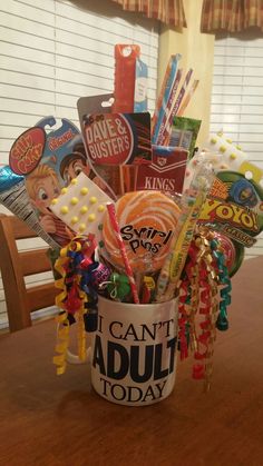 a cup filled with candy and candies on top of a table