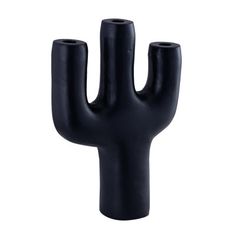 a black cactus shaped vase sitting on top of a table