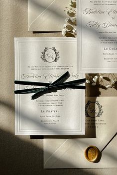 the wedding stationery is laid out on top of each other