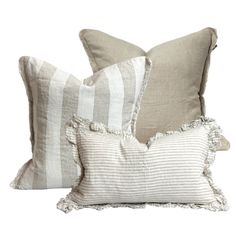 two pillows with ruffled edges and one pillow with tassels on the sides