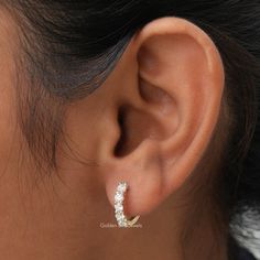 Colorless Round Cut Moissanite Huggies Earring In 14K Solid Gold. Crafted To Perfection, These Earrings Are The Ideal Wedding Gift For Her. With Their Timeless Design And Stunning Colorless Round-Cut Moissanite Stones, They Will Add An legant touch to any outfit.  𝐒𝐊𝐔: - GBJ1059 ✥ 𝐌𝐚𝐢𝐧 𝐒𝐭𝐨𝐧𝐞 𝐃𝐞𝐭𝐚𝐢𝐥𝐬 ↣ Shape: Round Cut ↣ Type: Moissanite ↣ Weight: 1.00 CTW (App.)  ↣ Color/Clarity: Colorless/VVS ↣ Making Process: Handmade - Crafted by our experienced team ✥ 𝐄𝐚𝐫𝐫𝐢𝐧𝐠𝐬 𝐃𝐞𝐭𝐚𝐢𝐥𝐬 ↣ Metal Purity: Solid Gold (10KT, 14KT, 18KT); Silver (925 Sterling, 935 Argentium), 950 Platinum ↣ Metal Tone: Yellow, White, Rose ↣ Stamp: Yes ✥ 𝐅𝐨𝐥𝐥𝐨𝐰 𝐔𝐬 Instagram:  @goldenbirdjewels  Facebook: @goldenbirdjewels Pinterest: @goldenbirdjewels Small Hoop Cubic Zirconia Diamond Earrings, Dazzling Small Hoop Earrings For Wedding, Dazzling Diamond-accented Hoop Earrings For Wedding, Dazzling Hoop Earrings With Diamond Accents For Wedding, Wedding Hoop Earrings With Diamond Accents And Cubic Zirconia, Dazzling Small Hoop Wedding Jewelry, Dazzling Small Hoop Jewelry For Wedding, Dazzling Yellow Gold Hoop Earrings For Wedding, Wedding Hoop Earrings With Diamond Accents In Diamond White