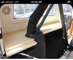 an umbrella is sitting on the back seat of a vehicle in front of a window