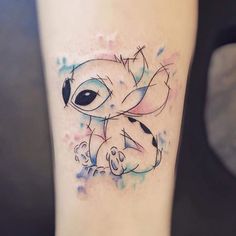 a small elephant tattoo on the right inner forearm and leg with watercolor splashs