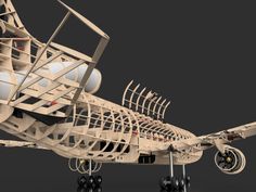 a wooden model of an airplane with wheels